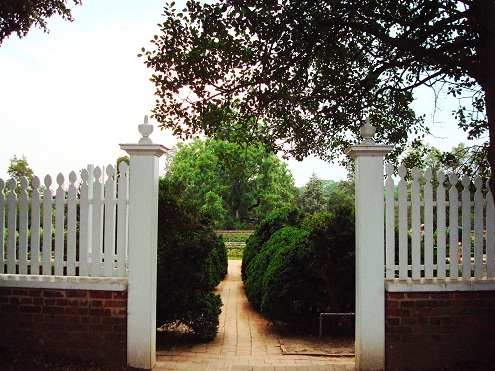 white fence and brick walkway