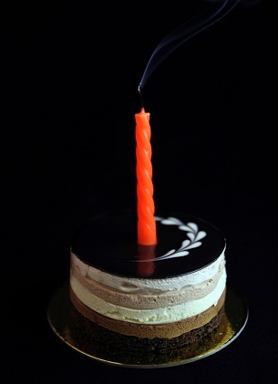 white and chocolate cake with a candle