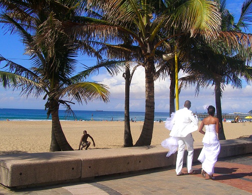 newlyweds walking on beach