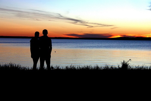 couple at river at sunset