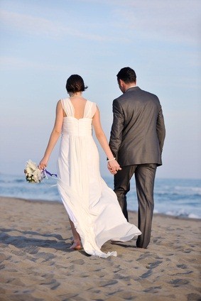 newlyweds walking on beach