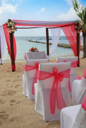 wedding arch and chairs on beach