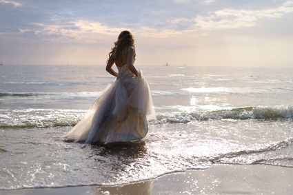 bride standing at ocean shore