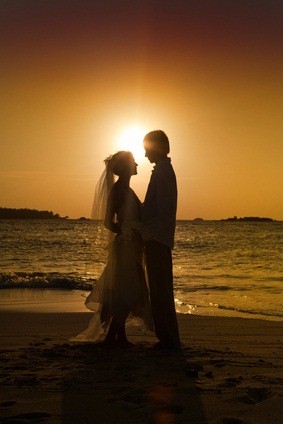 newlyweds at ocean sunset