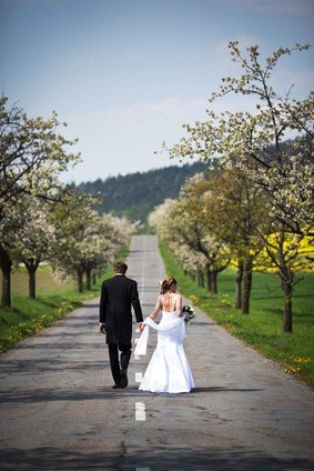 newlyweds walking on road