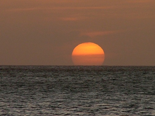 sun setting over ocean