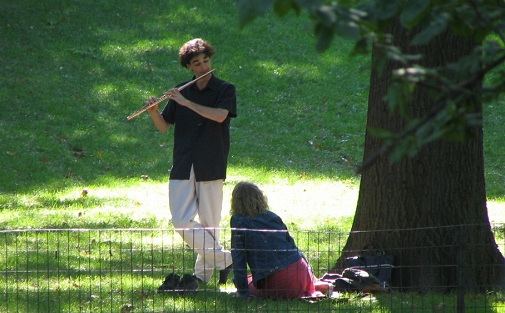 man playing flute for a woman