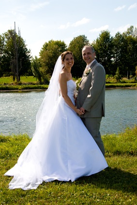 bride and groom by lake