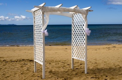 white wedding arch at ocean