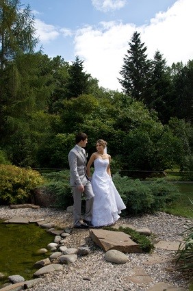 bride and groom at pond