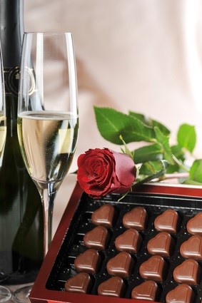 champagne glass, rose and chocolates