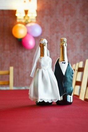 champagne bottles in gown and tuxedo