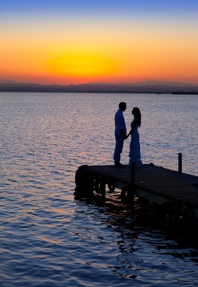 newlyweds at lake sunset