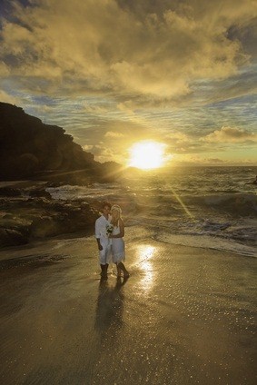 newlyweds at ocean sunset