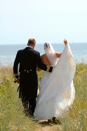 newlyweds walking to beach