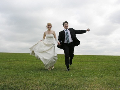 newlyweds running outside